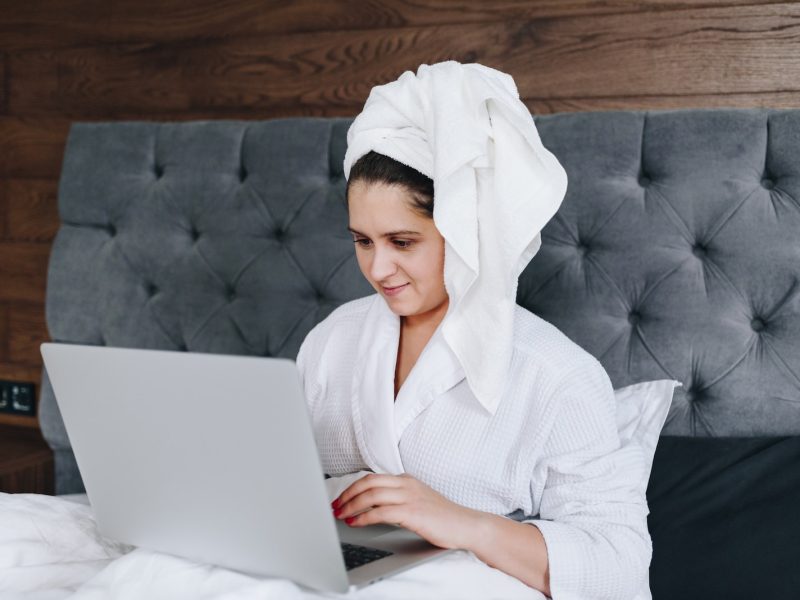 woman in white robe sitting on couch